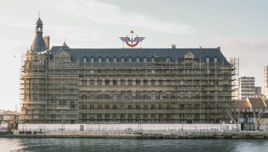 Scaffolding on a historic waterfront building under renovation. — 5 Skin-Friendly Fashion Pieces (and Fabrics) to wear During