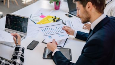 Business team reviewing graphs and data in an office setting. — A Month Is Usually Enough To Improve Your Credit Score