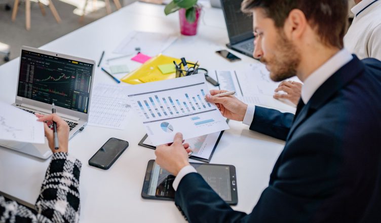 Business team reviewing graphs and data in an office setting. — A Month Is Usually Enough To Improve Your Credit Score