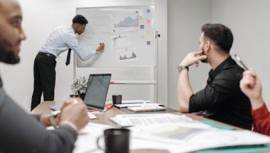 Colleagues in a business meeting discussing data and strategies at the office. — Banners are a Type of Signage Many Tucson Bu
