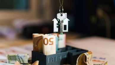 House key over Euro banknotes symbolizes real estate investment and financial planning. — Can Small Investors Invest in Mutua