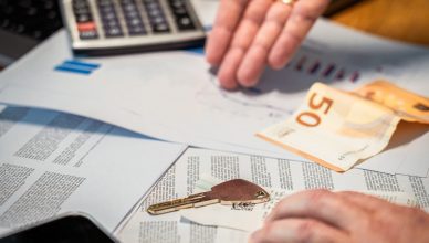 Hands examining financial documents, a 50 euro note, and a key — Can you beat the Forex market