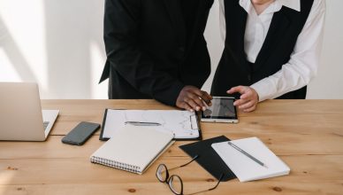 Two professionals collaborating over charts and tablet in a modern office setting. — Efficient steps to overcome the failures