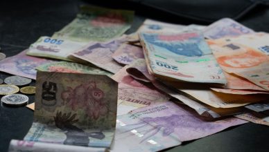 A mix of international banknotes and coins displayed on a table, highlighting diverse world currencies. — Factors to Consider
