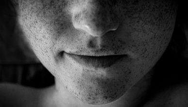 Artistic black and white close-up of a face highlighting freckles and lips. — Find New Ways to Earn Money Today