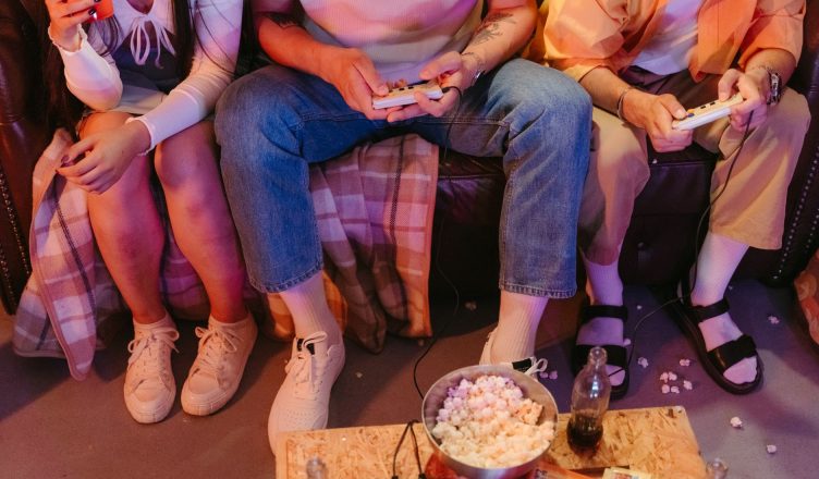 A group of teenagers enjoying a vintage gaming session indoors with snacks and drinks. — Gain an Unfair Advantage with Our Va