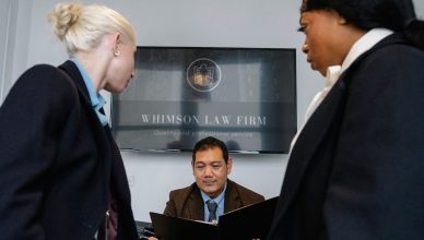 Diverse colleagues gathering in conference hall of law firm and discussing details of contract while working together — Get t