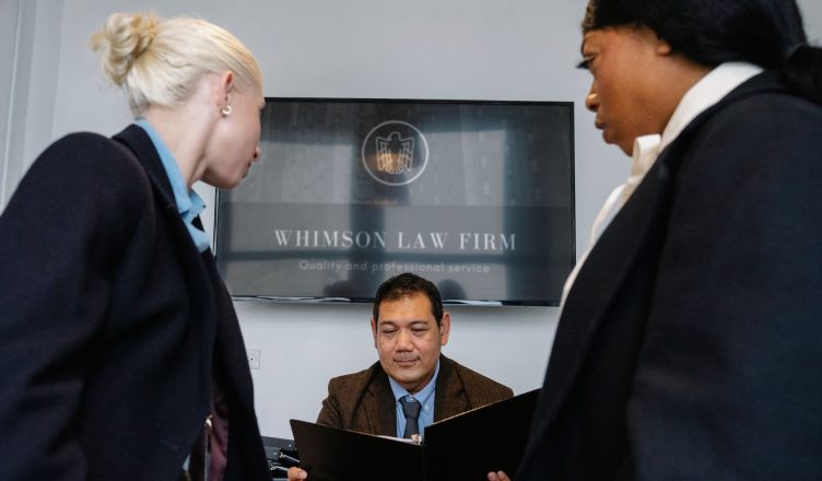 Diverse colleagues gathering in conference hall of law firm and discussing details of contract while working together — Get t