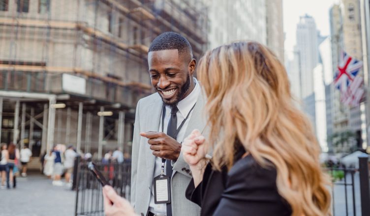 Two business professionals engage in lively conversation on an urban street, sharing insights. — Grow your online business te