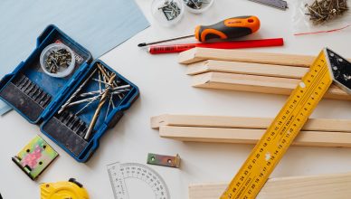 A top view of various woodworking tools and materials on a white table. — High-Quality MDF Cut to Size Panels Designed for Sm