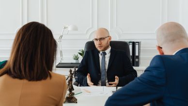 A professional business meeting with a lawyer and clients in a modern office setting. — Hiring labor law attorney in Californ