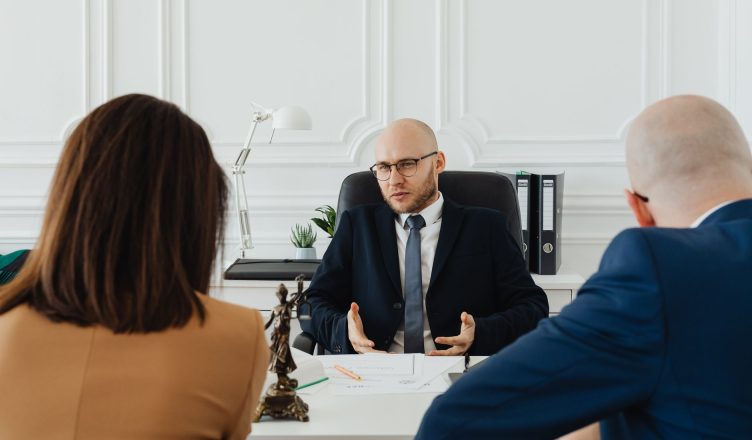 A professional business meeting with a lawyer and clients in a modern office setting. — Hiring labor law attorney in Californ