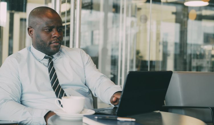Focused businessman uses laptop in stylish cafe, sipping coffee. Perfect for business or lifestyle themes. — How important is