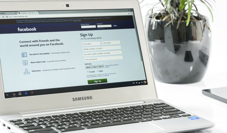 Open Samsung laptop showing Facebook sign-up page next to a potted plant. Ideal for technology themes. — How to become the gr