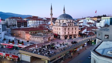 Aerial shot of Bolu city with a prominent mosque and bustling streets during twilight. — How to Construct Your Tiny Room Spac