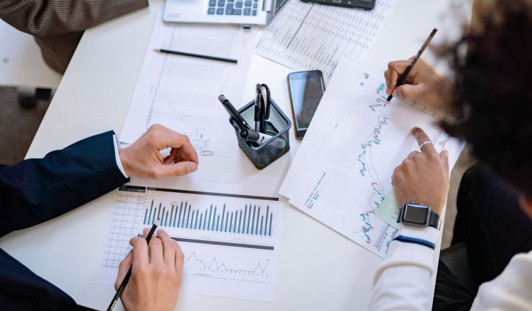 Business team analyzing financial charts and graphs during a collaborative meeting. — How Your Credit Score and History Affec
