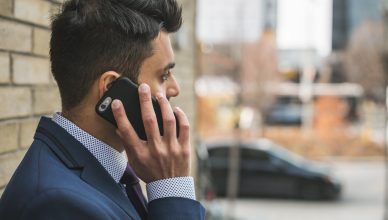 Professional man in suit making a phone call outside in city setting. — Need money instantly to come out of the problem: