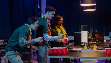 Group of male colleagues enjoying a fun beer pong game during an office party night. — PC Game Hacks-what are Benefits