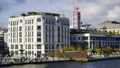 Scenic view of historical buildings on Istanbul's waterfront, bustling with activity. — Polished Plastering: Your Chances to