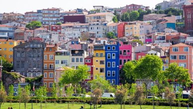 Vibrant multi-colored facades in a residential district of Istanbul, Turkey, with green park and trees. — Secrets of the Ente