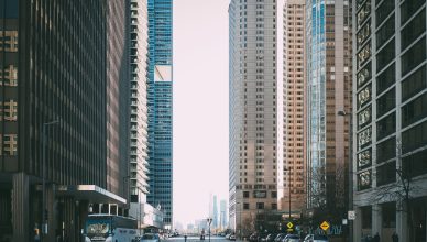 Vibrant city street scene with tall skyscrapers and city life full of cars and pedestrians. — Steps to Create a Compare and C