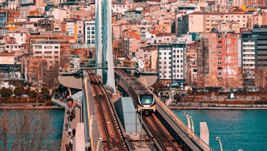 Metro train crossing a bridge in Istanbul with a vibrant cityscape backdrop. — How to Make Your Application Shine for