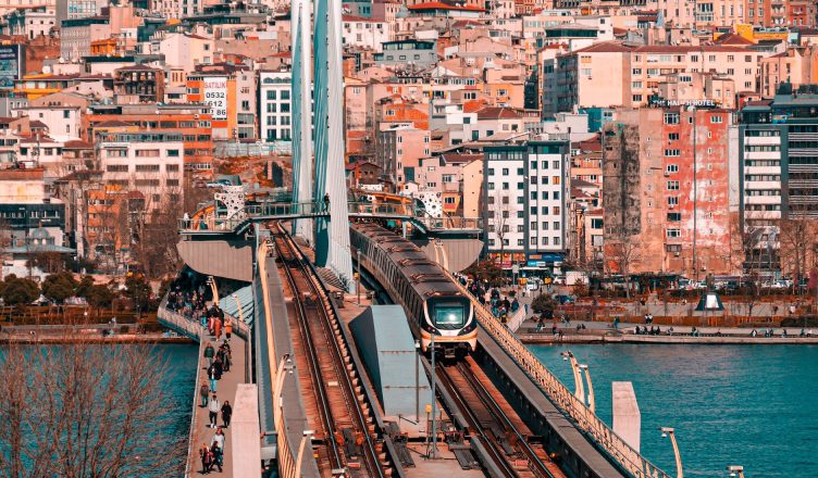 Metro train crossing a bridge in Istanbul with a vibrant cityscape backdrop. — How to Make Your Application Shine for