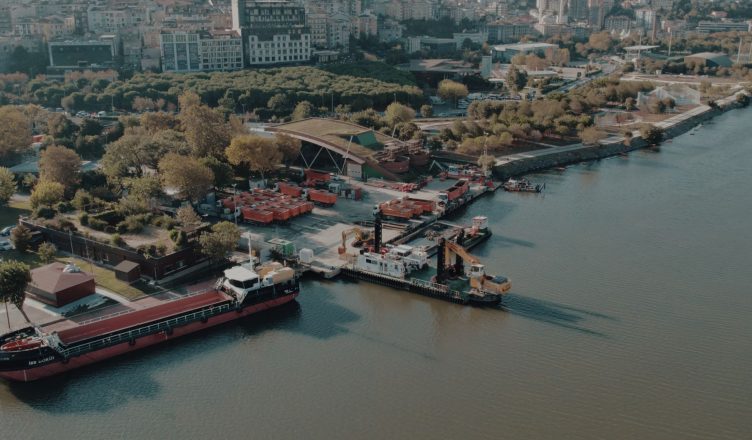 Aerial shot of Istanbul waterfront showing ships docked along a lush green shoreline. — Make Sure You're On Top with