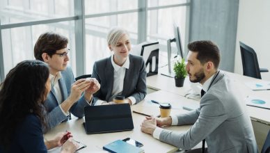 Group of professionals having a discussion in a modern office setting with natural light. — The current revolution of the ind