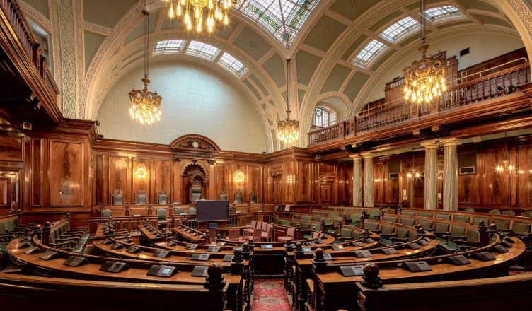 A beautifully designed chamber room with ornate woodwork and chandeliers in the UK. — The True Cost of a Speeding Ticket
