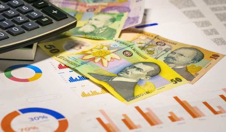 Romanian banknotes with graphs and calculator illustrating finance concepts. — The ultimate guide to building your wedding bu