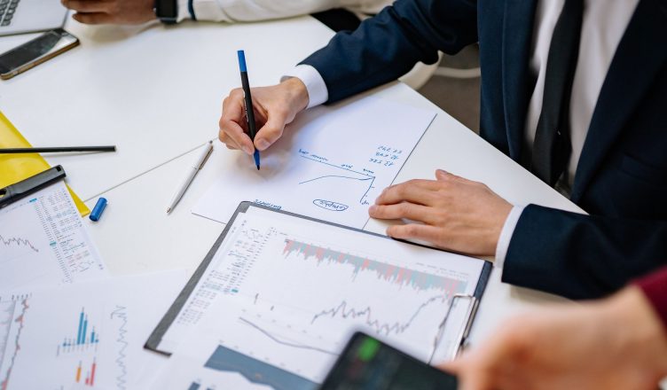 Professionals analyzing financial charts in a corporate setting. — Things that nobody told you about online poker!!
