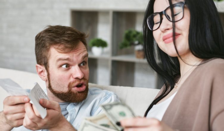 Interracial couple arguing over bills and cash at home. — Trading and investment without any hassle through crypto trading we