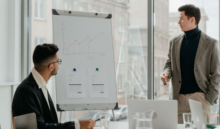 Professionals discussing a business chart in a modern office. — Understanding the Role of HCG in TRT