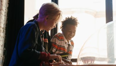 Teenagers having fun while playing games at an indoor arcade, showcasing youthful joy and friendship. — What are the differen