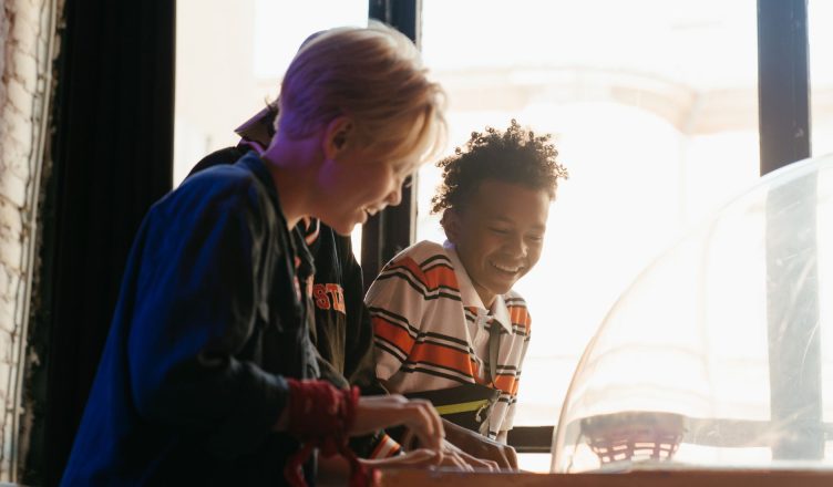 Teenagers having fun while playing games at an indoor arcade, showcasing youthful joy and friendship. — What are the differen