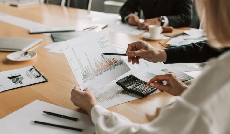 Professionals reviewing financial graphs and charts during a meeting. — What is an accounting firm and why should you seek as