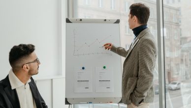 Two professionals examining graphs during an office presentation. — Where to Begin When Making a New Wardrobe?