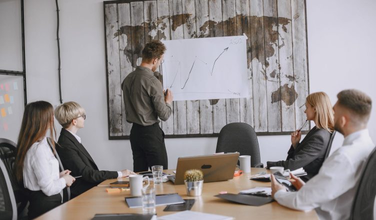 Group of business professionals discussing strategies with growth chart in conference room. — Why an automated industrial sec